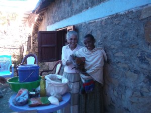 Hila Bram presents a chicken to one of the Meketa beneficiaries.