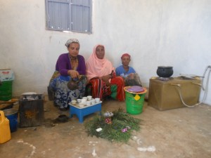 Residents sitting by in of the four gas stoves