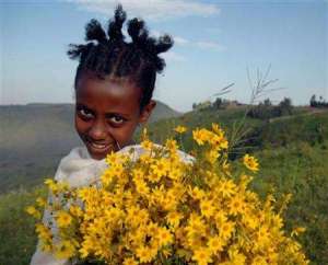 A girl with traditional Enkutatash wild flowers!  Image from http://bit.ly/1wg2p8I