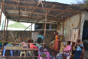 The playgroup children under the newly built outdoor shelter
