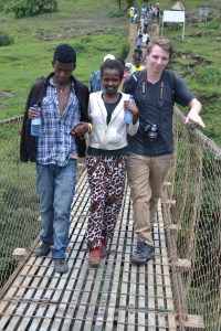 Joseph helping a child across the bridge